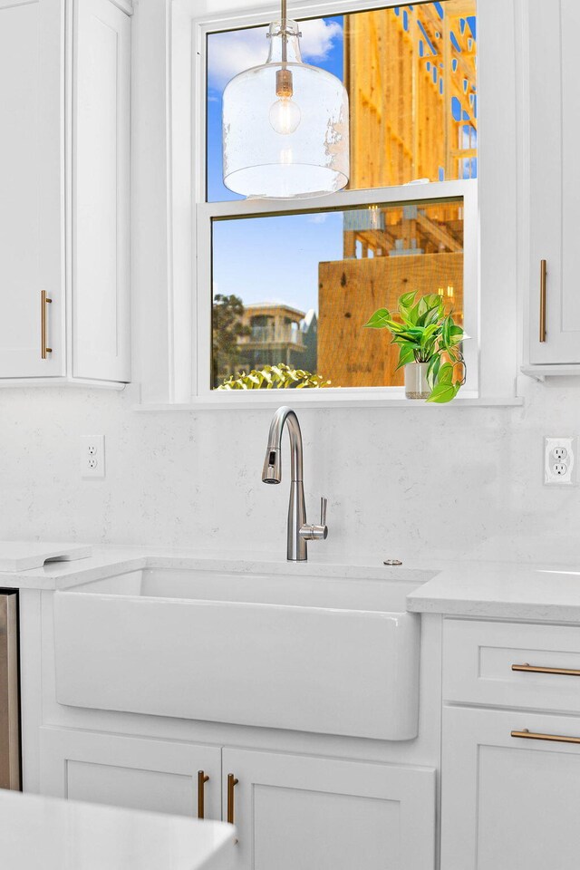 room details with white cabinetry and sink