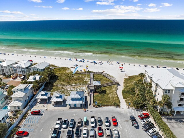 drone / aerial view featuring a beach view and a water view