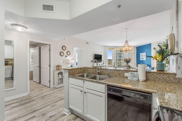 kitchen featuring a chandelier, black dishwasher, decorative backsplash, and sink