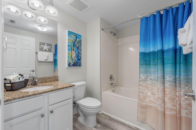 full bathroom with shower / bath combination with curtain, toilet, hardwood / wood-style flooring, and vanity