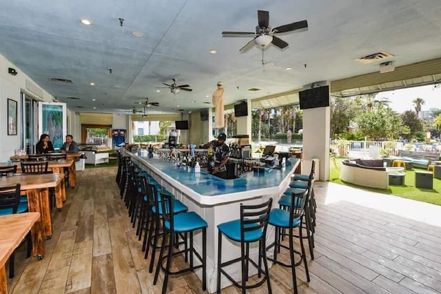 interior space with ceiling fan and hardwood / wood-style flooring