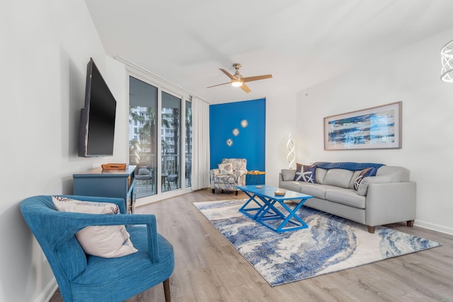 living room featuring light hardwood / wood-style flooring, ceiling fan, and floor to ceiling windows