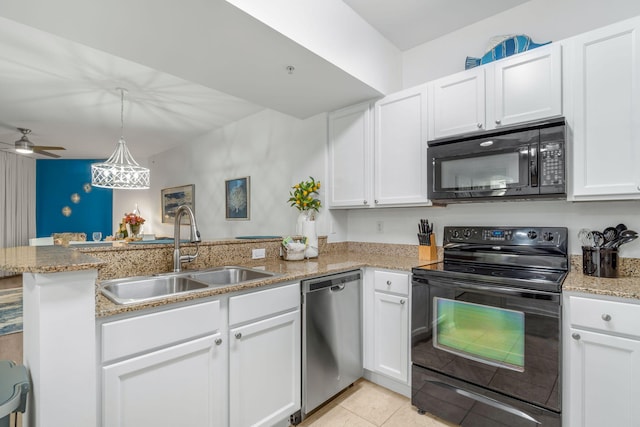 kitchen with light stone countertops, black appliances, kitchen peninsula, sink, and ceiling fan