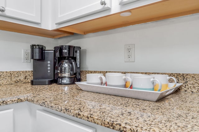 interior details with light stone counters and white cabinets