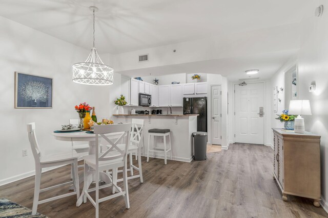 dining space featuring light wood-type flooring