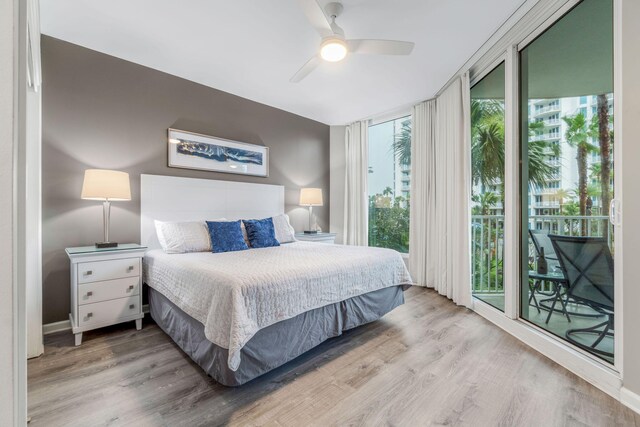 bedroom with light hardwood / wood-style flooring, access to exterior, and ceiling fan