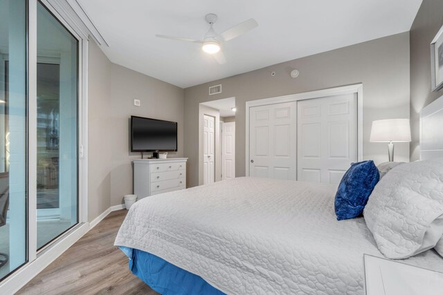 bedroom featuring hardwood / wood-style flooring, ceiling fan, and a closet