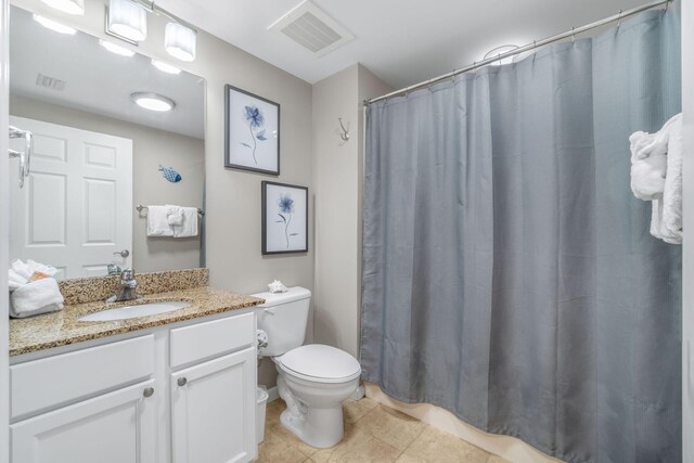 bathroom with vanity, toilet, curtained shower, and tile patterned floors