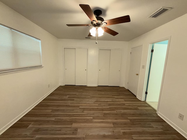4 3rd Ave, Shalimar, FL 32579 - unfurnished bedroom featuring multiple closets, baseboards, dark wood-type flooring, and visible vents