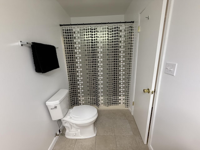 4 3rd Ave, Shalimar, FL 32579 - bathroom with toilet, tiled shower, tile patterned floors, and baseboards