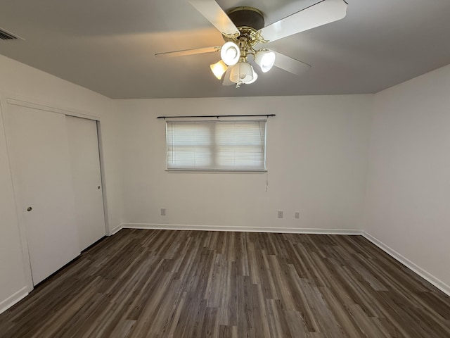 4 3rd Ave, Shalimar, FL 32579 - unfurnished bedroom with a ceiling fan, a closet, baseboards, visible vents, and dark wood-style floors