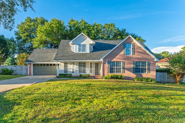 view of front facade with an attached garage, covered porch, fence, and concrete driveway