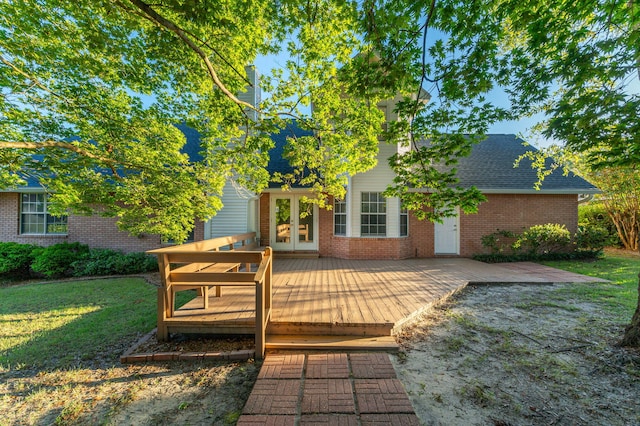 wooden deck with a yard and french doors