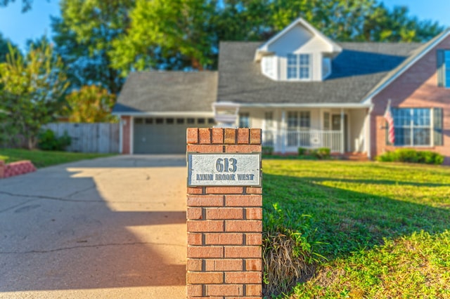 view of front facade with a front yard, driveway, and an attached garage