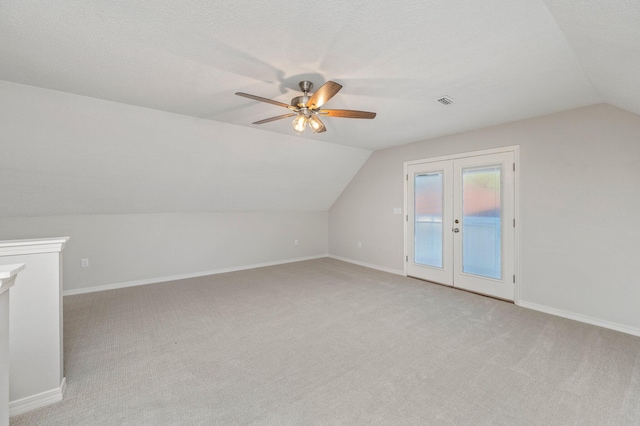 bonus room featuring vaulted ceiling, baseboards, visible vents, and light colored carpet