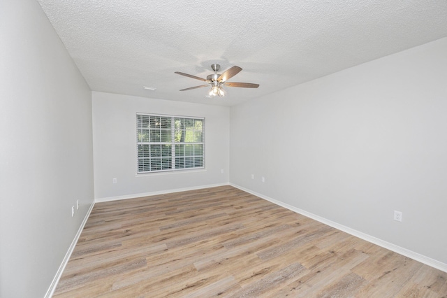 unfurnished room featuring a textured ceiling, light wood finished floors, a ceiling fan, and baseboards