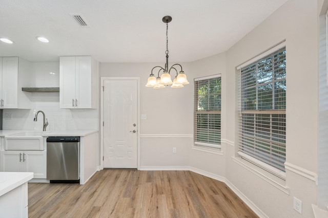 kitchen featuring a sink, visible vents, white cabinets, light countertops, and dishwasher