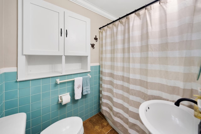 bathroom with toilet, crown molding, sink, tile walls, and a shower with curtain