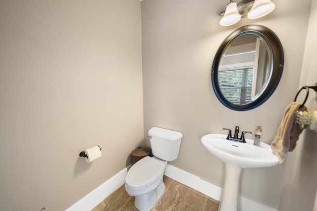 bathroom with toilet and tile patterned flooring