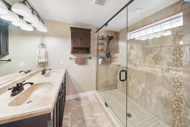 bathroom with vanity and a shower with shower door