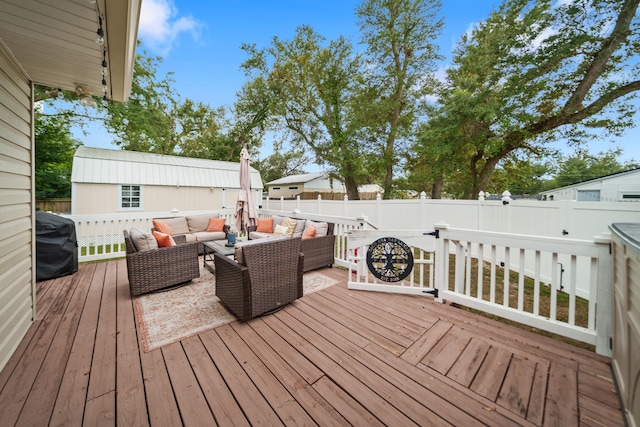 wooden terrace featuring outdoor lounge area and a grill