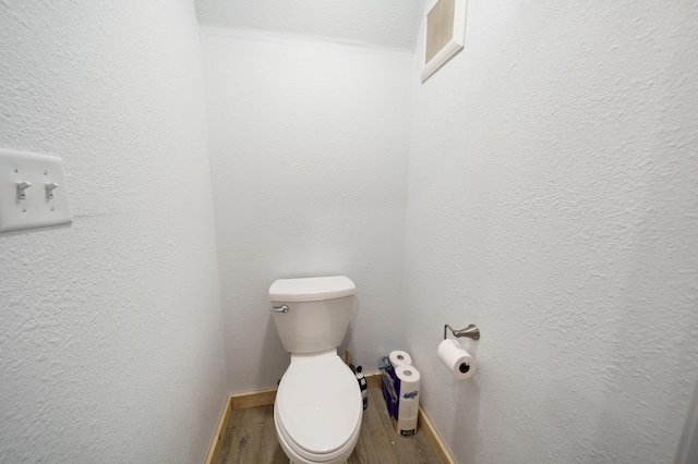 bathroom featuring toilet and hardwood / wood-style flooring