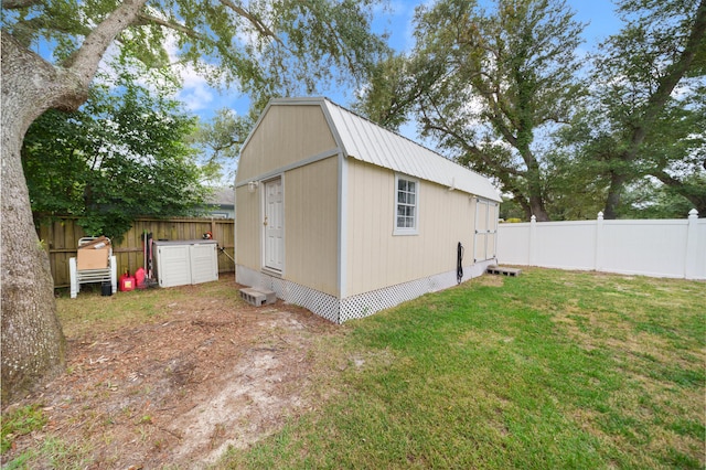 view of home's exterior with a yard and a shed