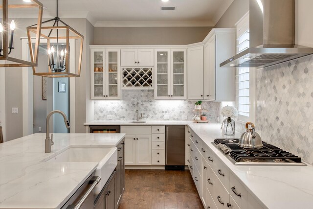 kitchen featuring white cabinets, sink, wall chimney exhaust hood, appliances with stainless steel finishes, and light stone counters