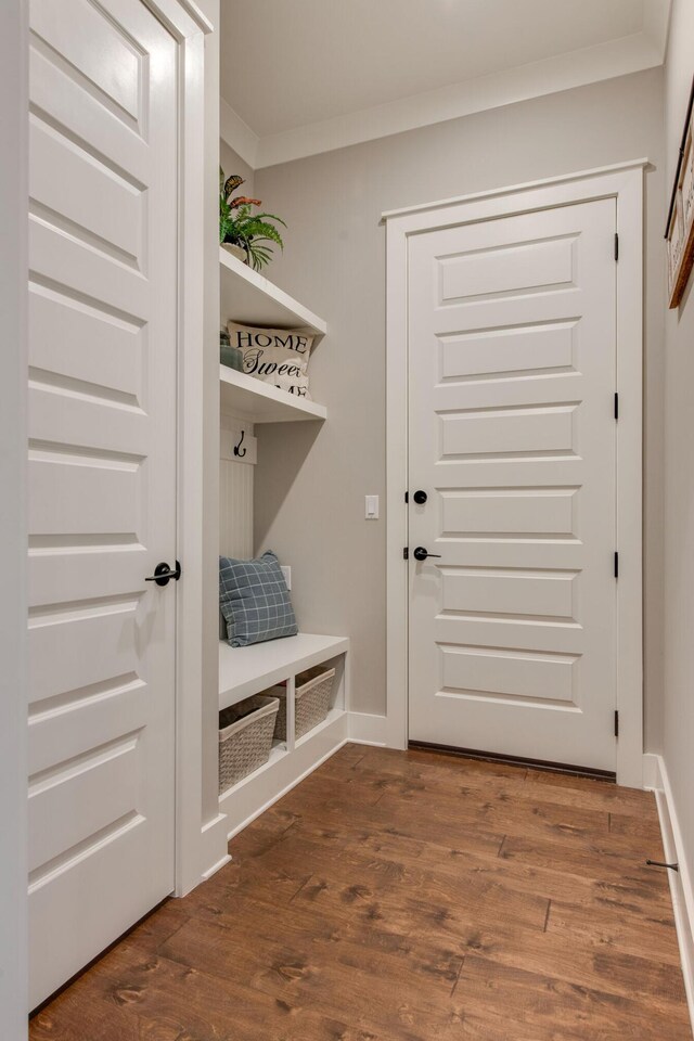 mudroom featuring dark hardwood / wood-style flooring and ornamental molding