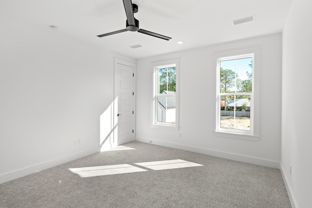 carpeted empty room featuring ceiling fan