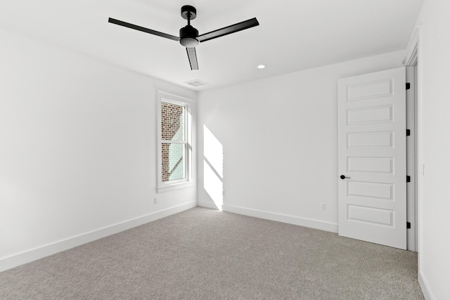 unfurnished room featuring ceiling fan and light colored carpet