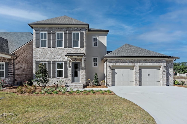 view of front of property featuring a garage and a front lawn