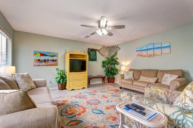 living room featuring a textured ceiling and ceiling fan