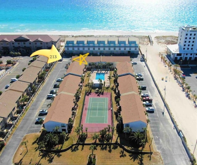 birds eye view of property with a water view and a view of the beach