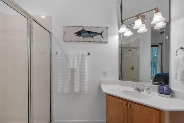 bathroom with vanity, a notable chandelier, and walk in shower