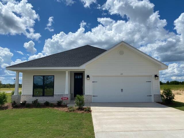 view of front of home with a front yard and a garage