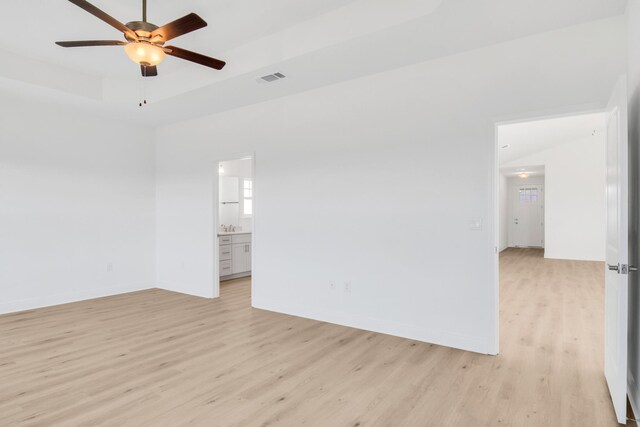 empty room featuring lofted ceiling, ceiling fan, and light hardwood / wood-style floors