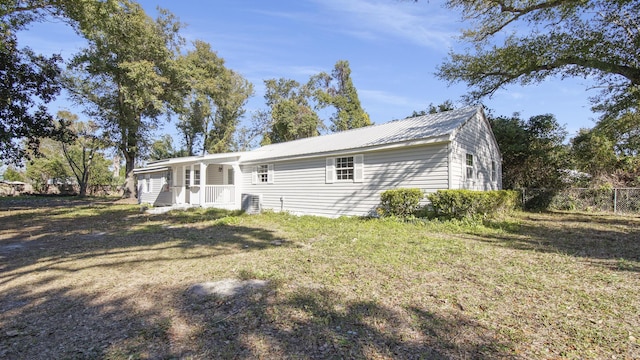 view of front of property with a front yard and metal roof