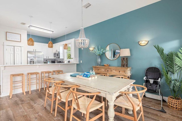 dining area featuring wood-type flooring