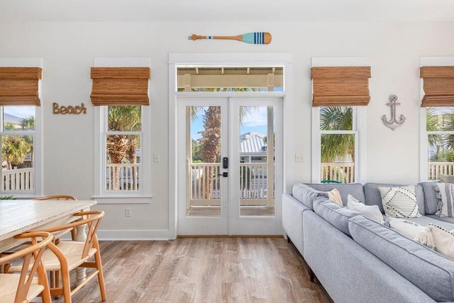 doorway to outside with plenty of natural light, light hardwood / wood-style flooring, and french doors