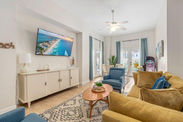 tiled living room featuring french doors and ceiling fan