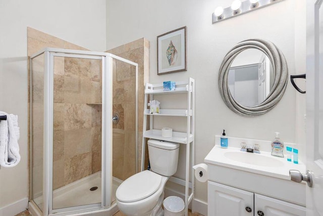 bathroom featuring vanity, toilet, and walk in shower