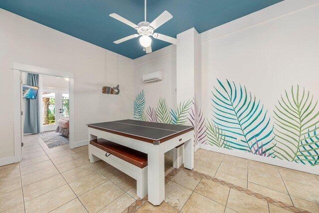 playroom featuring a wall mounted AC, ceiling fan, and light tile patterned flooring