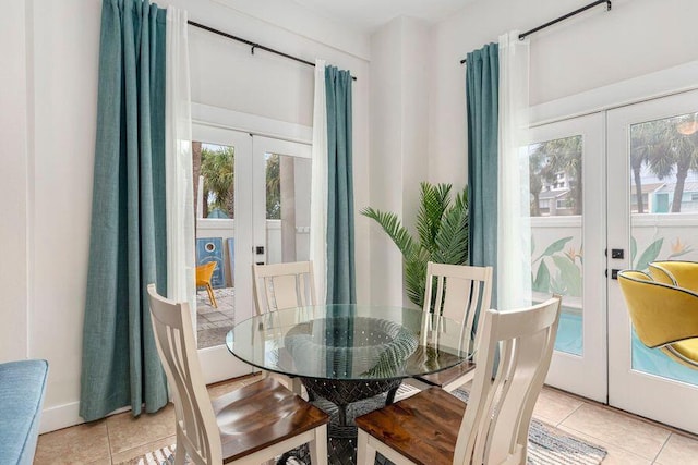 tiled dining area featuring french doors