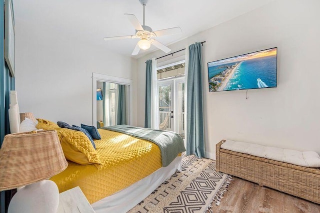 bedroom with ceiling fan, hardwood / wood-style flooring, and access to outside