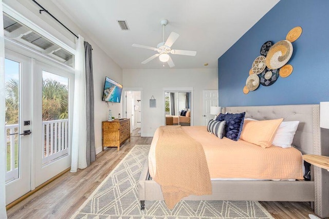 bedroom featuring french doors, light hardwood / wood-style floors, access to exterior, and ceiling fan