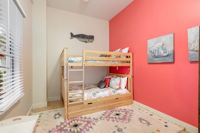 bedroom with tile patterned flooring and vaulted ceiling