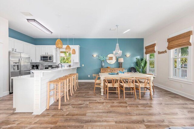 dining area featuring light hardwood / wood-style flooring and sink