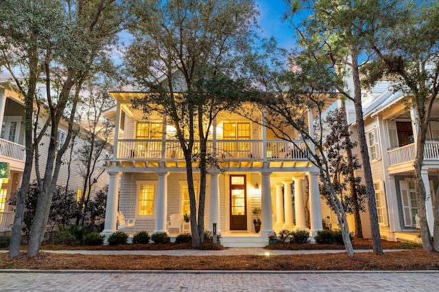 view of front facade featuring a balcony and covered porch