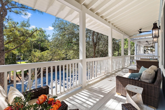 wooden terrace featuring ceiling fan